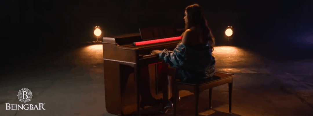 Tess Mon Pere playing the piano while singing